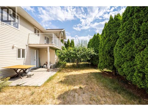 Backyard with thriving plum tree at 5804 Richfield Drive, Westmount, Vernon