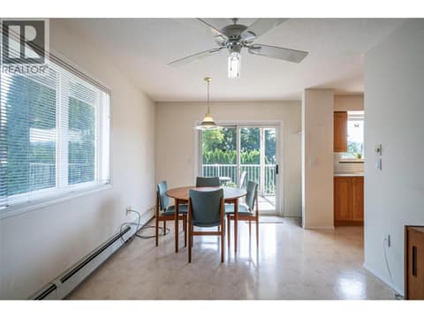 Spacious dining room and doors to balcony at 5804 Richfield Drive, Westmount, Vernon