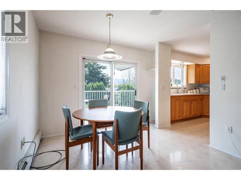 Spacious dining room and doors to balcony at 5804 Richfield Drive, Westmount, Vernon