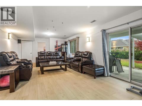 Bottom Floor Living Room with door leading to Backyard at 1730 Simpson Court, Rutland South, Kelowna
