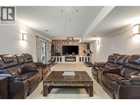 Bottom Floor - Spacious Rec Room/ Living Room with Electric Fireplace at 1730 Simpson Court, Rutland South, Kelowna
