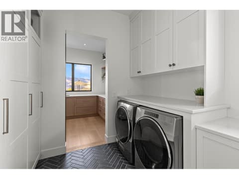 Main floor laundry off the butler pantry area at 74 Red Sky Court, Wilden, Kelowna