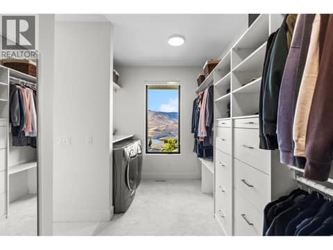 Primary walk in closet with private laundry at 74 Red Sky Court, Wilden, Kelowna