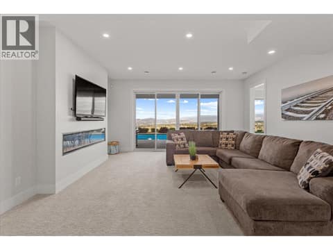 Lower floor 2nd living room space with walkout to pool deck at 980 Ledgeview Court, Upper Mission, Kelowna