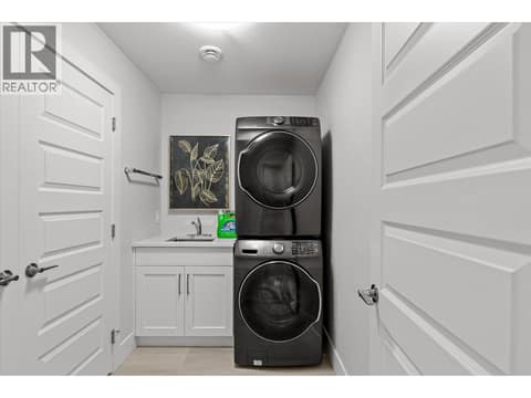 Lower floor laundry room with additional storage at 980 Ledgeview Court, Upper Mission, Kelowna