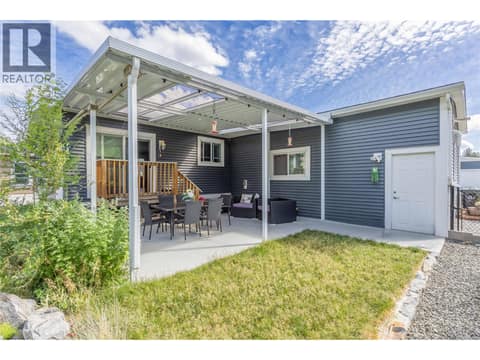 Backyard with access to the attached double garage at 1835 Nancee Way Court Unit# 48, West Kelowna Estates