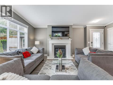 Curl up next to the gas fireplace in the living room at 1835 Nancee Way Court Unit# 48, West Kelowna Estates