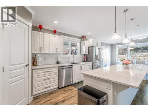Enjoy the large island and walk-in pantry in the kitchen at 1835 Nancee Way Court Unit# 48, West Kelowna Estates