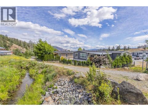 Enjoy the path and creek that border the back of the property at 1835 Nancee Way Court Unit# 48, West Kelowna Estates