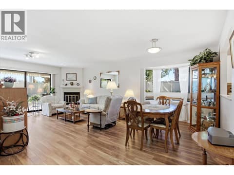 Open concept living room and dining room with sliding doors to private patio at 1765 Leckie Road Unit# 201, Springfield/Spall, Kelowna