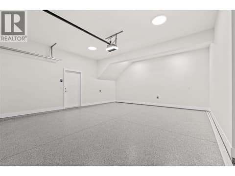 Attached Double-Car Garage | Lower Level - With 10ft ceilings and epoxy floors at 1448 Whistling Pine Place, Wilden, Kelowna