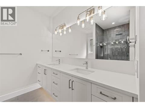 Primary Ensuite | Upper Level - Bathroom #1 - 4 piece bathroom with heated floors, custom dual vanity & glass-enclosed tiled shower at 1448 Whistling Pine Place, Wilden, Kelowna