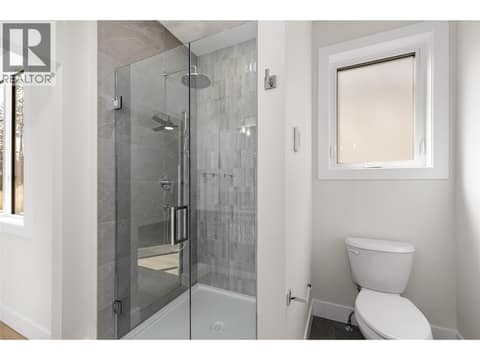 Primary Ensuite | Upper Level - Bathroom #1 - 4 piece bathroom with heated floors, custom dual vanity & glass-enclosed tiled shower at 1448 Whistling Pine Place, Wilden, Kelowna