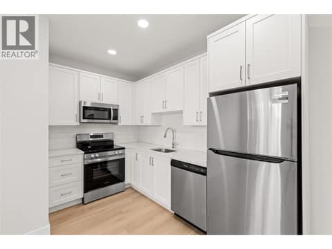 Suite Kitchen | Lower Level - Full sized kitchen with stainless steel appliances and hard surface countertops at 1448 Whistling Pine Place, Wilden, Kelowna