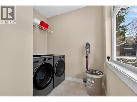 Laundry Room with Convenient Side Yard Access at 2478 Stone Grove Crescent, Shannon Lake, West Kelowna
