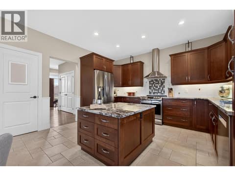 Spacious Kitchen With Large Island And Ample Prep & Storage Space at 2478 Stone Grove Crescent, Shannon Lake, West Kelowna