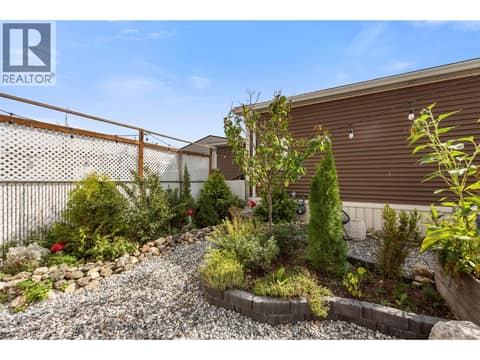 A mix of raised beds, mature plantings and low-maintenance landscaping makes excellent use of the yard. at 9020 Jim Bailey Road Unit# 174, Lake Country East / Oyama, Kelowna