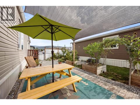 A shaded outdoor dining area creates the perfect spot for summer meals, morning coffee and relaxed evenings. at 9020 Jim Bailey Road Unit# 174, Lake Country East / Oyama, Kelowna