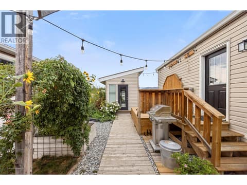 String lights, shaded seating and multiple gathering spaces make the yard especially inviting for summer evenings. at 9020 Jim Bailey Road Unit# 174, Lake Country East / Oyama, Kelowna