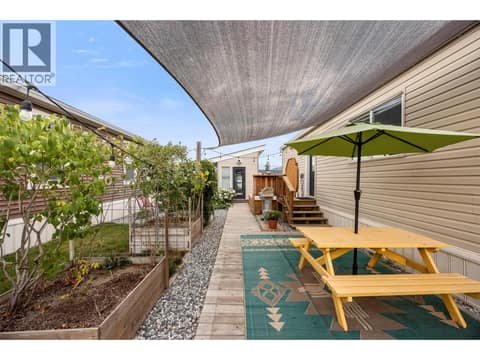 Thoughtfully designed outdoor space with gardens, pathways and multiple areas to sit, gather and unwind. at 9020 Jim Bailey Road Unit# 174, Lake Country East / Oyama, Kelowna