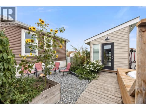 Wood pathways connect the outdoor living areas, gardens, deck and bonus detached space for an easy, functional flow. at 9020 Jim Bailey Road Unit# 174, Lake Country East / Oyama, Kelowna