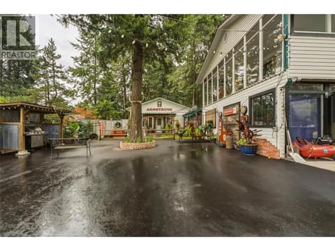 Left hand side of house - Tons of parking for tenants or guests! Carriage house straight ahead, covered BBQ area for guests on left, main home on right. at 3304 Sidney Crescent, Armstrong/ Spall., Spallumcheen
