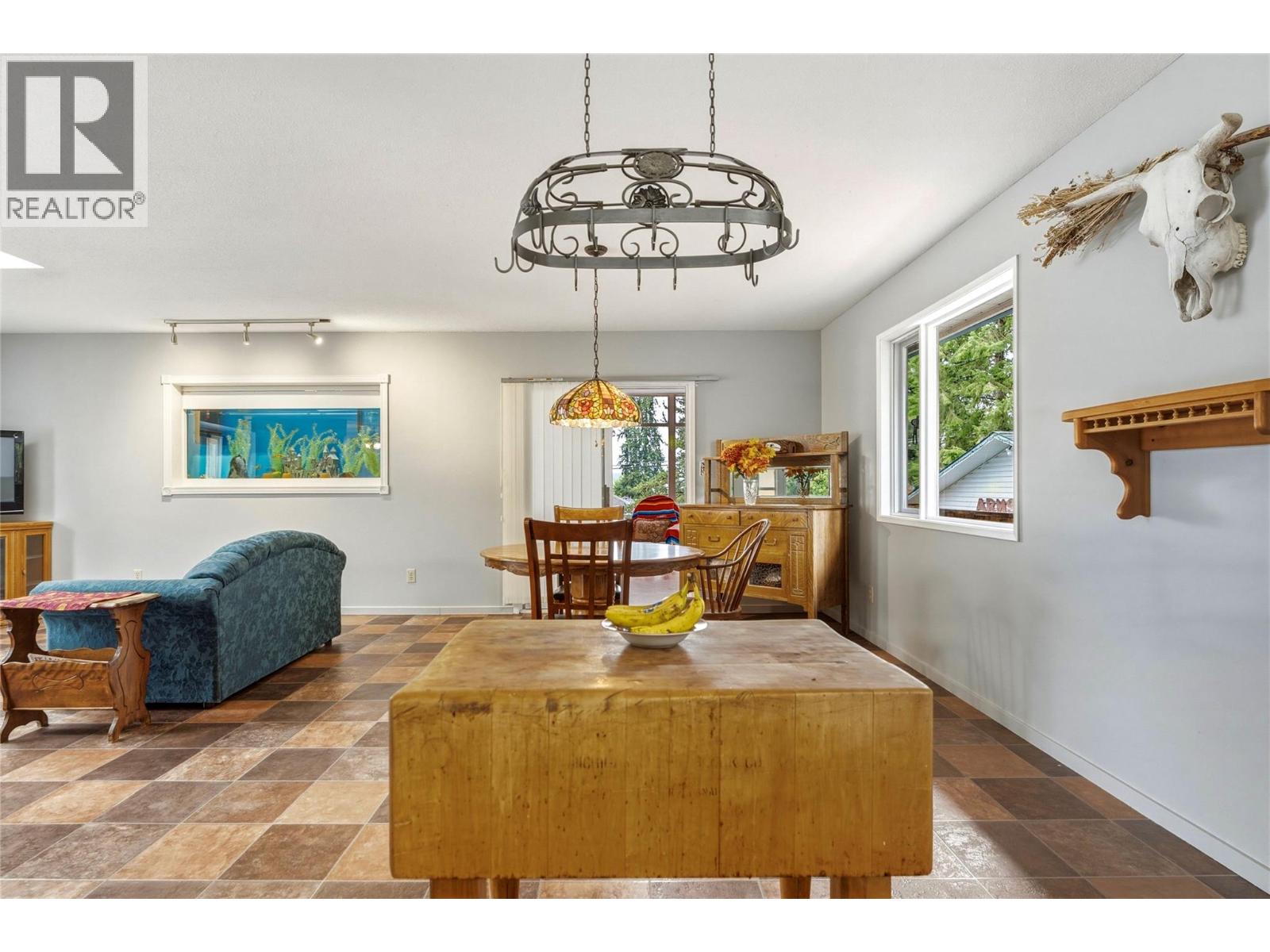 Main home - dining room, living room, and sliding door to enclosed deck/sunroom at 3304 Sidney Crescent, Armstrong/ Spall., Spallumcheen