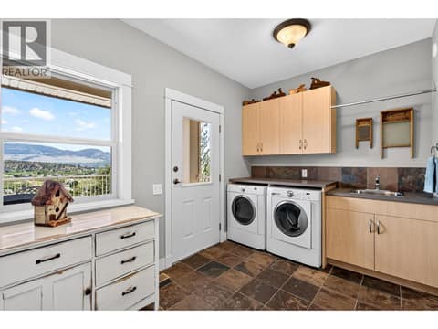 Spacious laundry room with ample storage and utility sink. at 471 Long Ridge Drive, Wilden, Kelowna