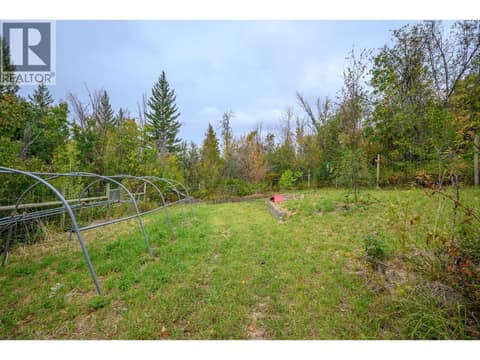 Fenced orchard and garden at 7936 McLennan Road, North BX, Vernon