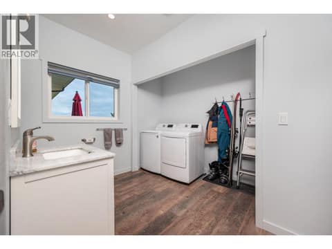 Main floor laundry and half bath at 7936 McLennan Road, North BX, Vernon