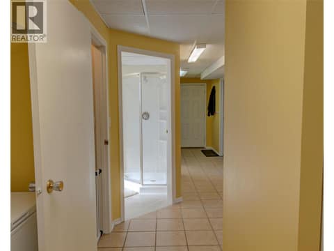 Main hallway downstairs to laundry room and bathroom at 5894 Dedecker West Road, North BX, Vernon