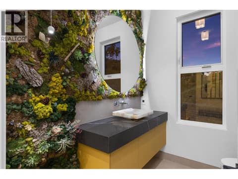 Unique powder room with preserved moss wall and onyx sink at 5584 Upper Mission Court, Kettle Valley, Kelowna