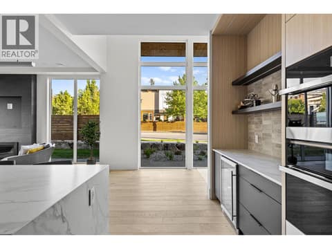 Bar area with beverage fridge and storage at 4983 Bucktail Lane, Upper Mission, Kelowna