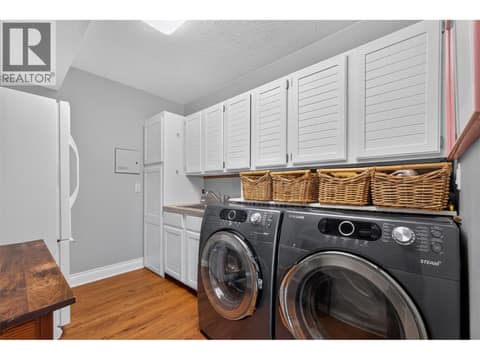 Laundry room & pantry on the main level at 1776 Keloka Drive, West Kelowna Estates