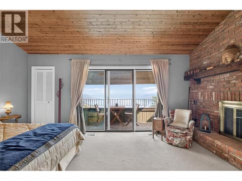 Second bedroom with private fire place & patio at 1776 Keloka Drive, West Kelowna Estates