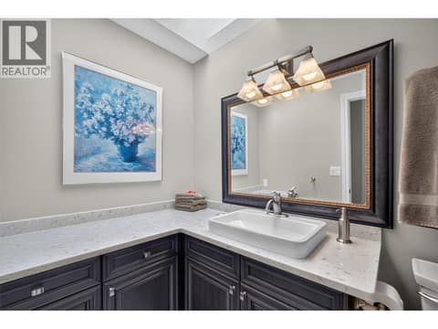 Second full bathroom on the upper level with a sky light at 1776 Keloka Drive, West Kelowna Estates