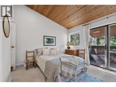 Third bedroom with it's own patio facing the trees at 1776 Keloka Drive, West Kelowna Estates