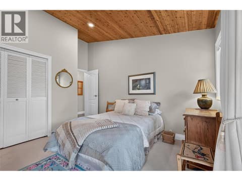 Third bedroom with it's own patio facing the trees at 1776 Keloka Drive, West Kelowna Estates