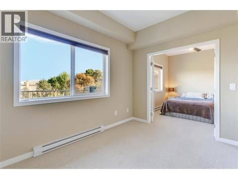 Den with large windows, offering flexibility for additional living space at 770 Rutland Road N Unit# 401, Rutland North, Kelowna
