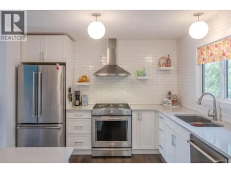 Main floor kitchen. at 127 Elm Avenue, Main South, Penticton