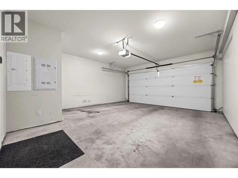 A second view highlights the generous size of this hard-to-find double garage, a standout feature within the complex. at 255 Taylor Road Unit# 18, Rutland South, Kelowna