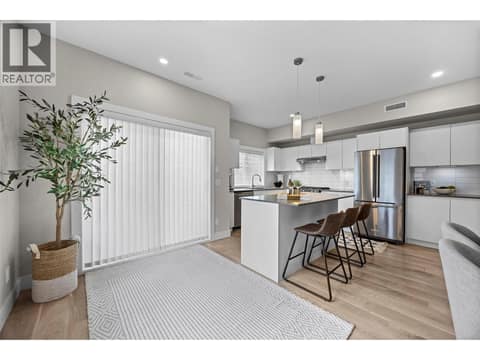 Bright kitchen with generous prep space and an oversized quartz island. at 255 Taylor Road Unit# 18, Rutland South, Kelowna
