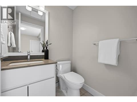 Convenient lower-level powder room with quartz countertop and modern finishes. at 255 Taylor Road Unit# 18, Rutland South, Kelowna