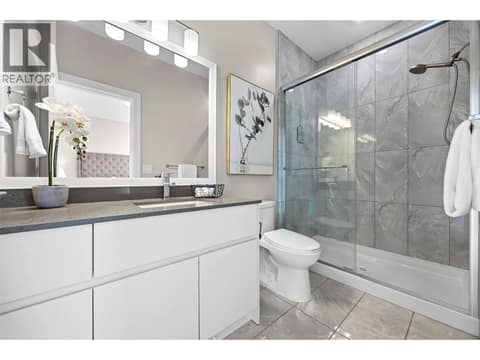 Private 3-piece ensuite with quartz countertop and glass-enclosed tiled shower. at 255 Taylor Road Unit# 18, Rutland South, Kelowna