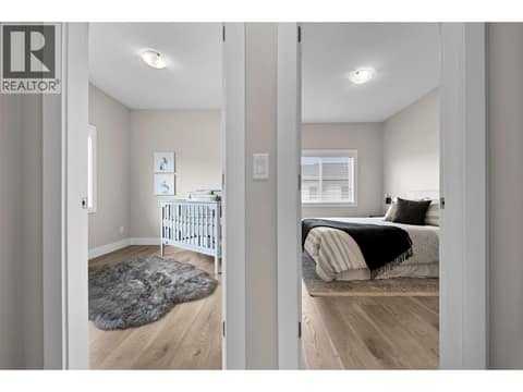 Two additional bedrooms are located together on the upper level, ideal for children, guests or a home office. at 255 Taylor Road Unit# 18, Rutland South, Kelowna