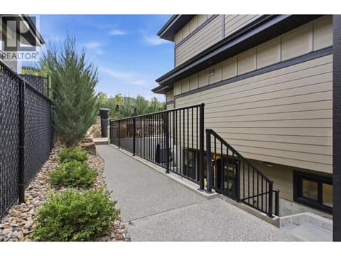 Left side of home- access to lower level legal suite at 1215 Ponds Avenue, Upper Mission, Kelowna