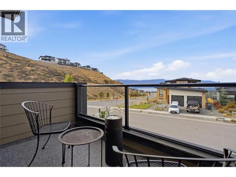 Primary bedroom- covered balcony with lake view at 1215 Ponds Avenue, Upper Mission, Kelowna