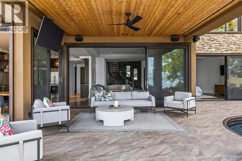 Comfortably enjoy the big game on the outdoor tv and sound system at 4165 Gellatly Road, Westbank Centre, West Kelowna