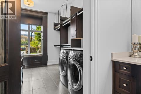 Primary Wing's Walk in closet with it's own laundry,  Wardrobe Lifts and Pasture View at 4165 Gellatly Road, Westbank Centre, West Kelowna
