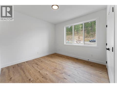 Main-floor bedroom at 2871 Copper Ridge Drive, Smith Creek, West Kelowna